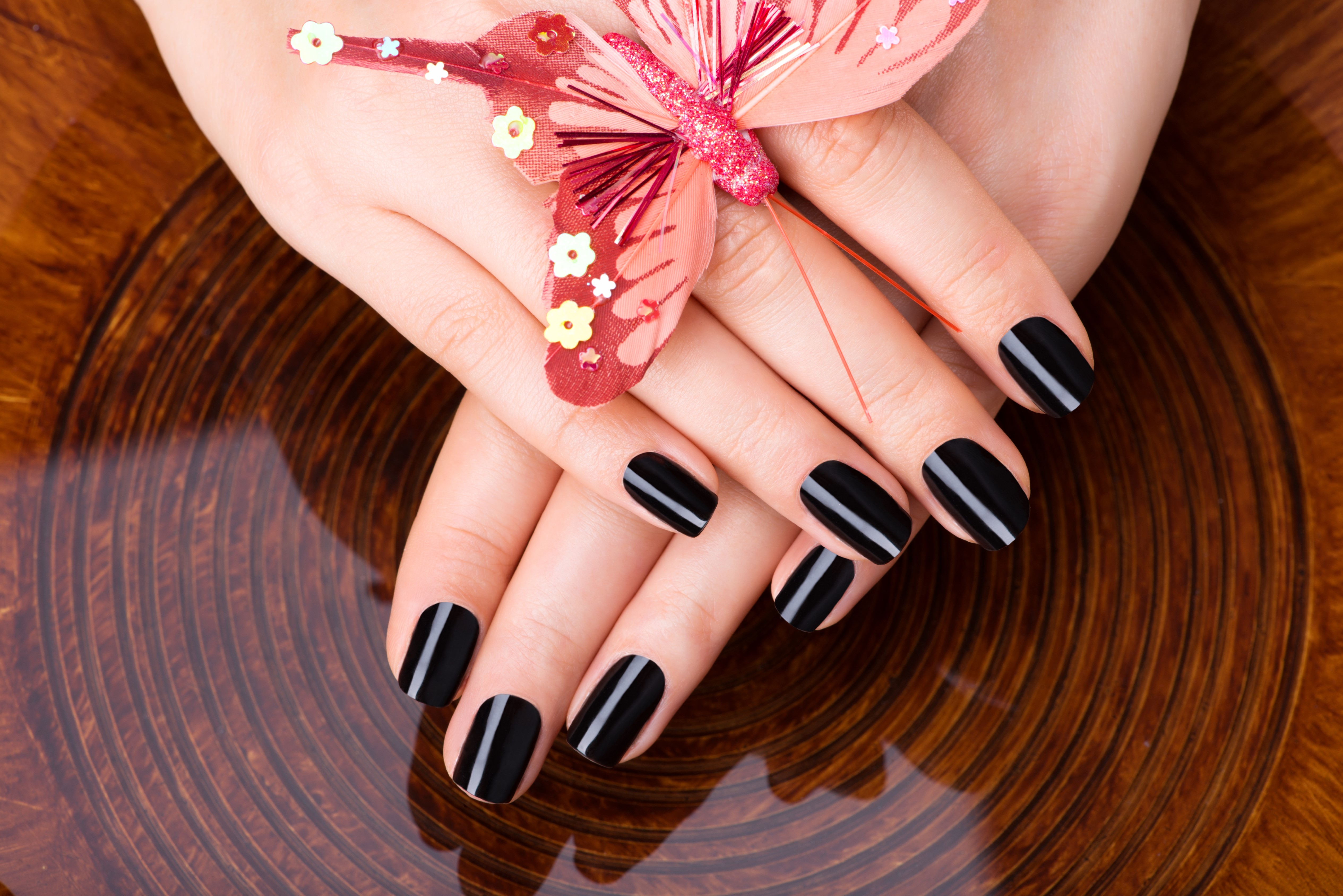 Woman applying dark blue shiny nail polish on middle finger Stock Photo -  Alamy